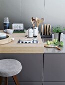 Kitchen utensils on counter with wooden worksurface