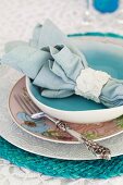 A place setting with a fabric napkin in a napkin ring