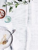 The remains of spaghetti on a plate, white background