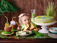 A little girl looking at a jungle party buffet