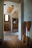 Bungalow foyer with painted floor and collection of besom brooms