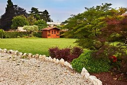 View from gravel area to summer house on lawns