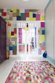 Colourful rug next to fitted cupboard in front of glass sliding doors