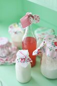 Jars and bottles decorated with scraps of romantic fabrics