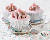Cupcakes decorated with raspberry and strawberry sweets
