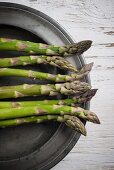 Green asparagus on a pewter plate