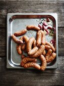 Salsiccia and garlic on a baking tray