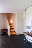 Entrance area with illuminated stair treads in modern house