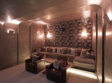 Rounded wall and ceiling cladding in elegant home cinema with upholstered seating, collection of cushions and atmospheric lighting
