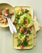 Warm salad with broad beans, peppermint, parsley, apple and croutons