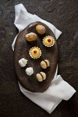 Four different types of biscuits on a stone platter (seen from above)