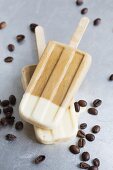 Espresso ice cream sticks surrounded by coffee beans