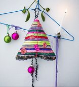 Hand-made Christmas-tree-shaped cushion made from colourful strips of fabric