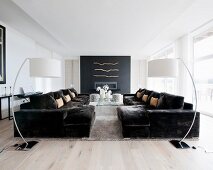 Symmetrical arrangement of sofas and arc lamps in living room