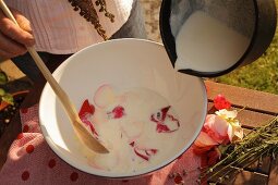 Milk and petals in bowl for making milk beauty treatment