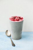 Homemade raspberry ice cream in a metal cup