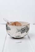A used teabag in a tea bowl with a fish pattern