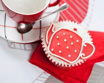 A cupcake decorated with a teapot