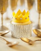 A cupcake decorated with a fondant crown