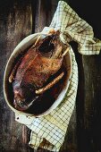 Grilled goose in a roasting dish