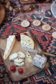 A cheese platter for a picnic-style Christmas meal on a kilim rug