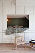 Floor-to-ceiling fitted cupboards and cubby bed in child's bedroom