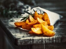 Country potatoes with rosemary in a paper bag