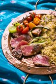 Fried tuna with garam masala served with bulgur and tomatoes