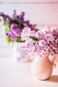 Bouquet of lilacs in ceramic jugs