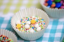 Sugar pearls and sugar sprinkles in a paper case