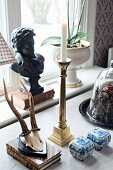 Roebuck hunting trophy, white and blue china pots, brass candlestick and bust on windowsill