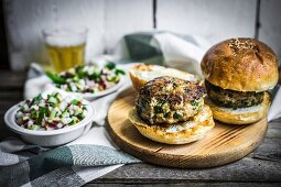 Healthy homemade burgers with vegetable salad and beer