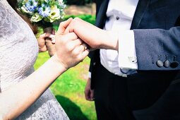 A bride and groom holding hands