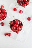 Fresh cherries in white cups (seen from above)