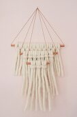 Wall-hanging made from knotted woollen yarn on copper rods