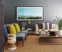Yellow scatter cushions on grey easy chairs in traditional living room with large artwork on grey wall