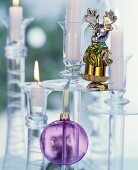Glass candlesticks festively decorated with glass baubles and moose figurine