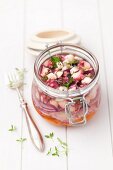 Marinated octopus with thyme and red onions in the flip-top jar