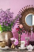 Coffee set, liqueur bottle, glass and romantic bouquet on table