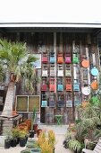 Colorful folding chairs and tables hung on board wall