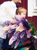 Child carrying flowers for midsummer festival