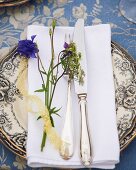 Place setting decorated with wild flowers for midsummer festival