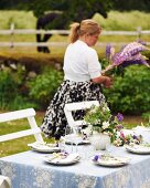 A garden table laid with meadow flowers for a mid-summer festival