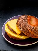 Sausage, egg and cheese breakfast sandwich on a poppy seed bagel