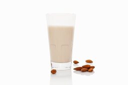 A glass of almond milk on a white surface