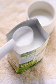 A carton of rice milk with a spoon