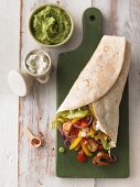 Chicken wrap with vegetables, guacamole and crème fraîche