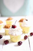 Muffins with cream and cherries