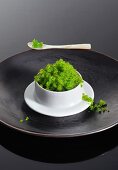 A bowl of green tobiko caviar from flying fish
