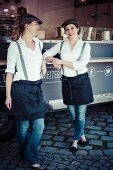 Two women in front of a food truck